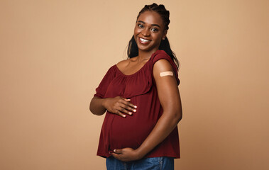 Safety vaccination during pregnancy cocnept. Cheerful pregnant young black woman got vaccinated...