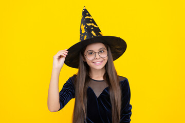 October 31. Teen girl in witch costume. Happy Halloween. Girl witch in Halloween costume isolated on yellow. Trick or treat. Celebrate All Hallows party holiday. All Hallows