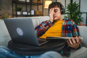 adult man with headphones watch course on laptop and study from home