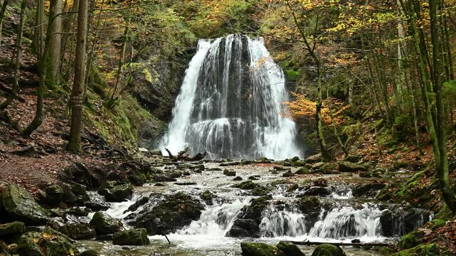 A twofold waterfall in a forest in autumn, with smaller waterfalls in the foreground, Josefsthaler Wasserf&auml;lle, Bavaria
