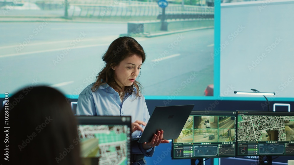 Poster supervisor gathering intelligence from satellite based surveillance footage, diverse team of operato