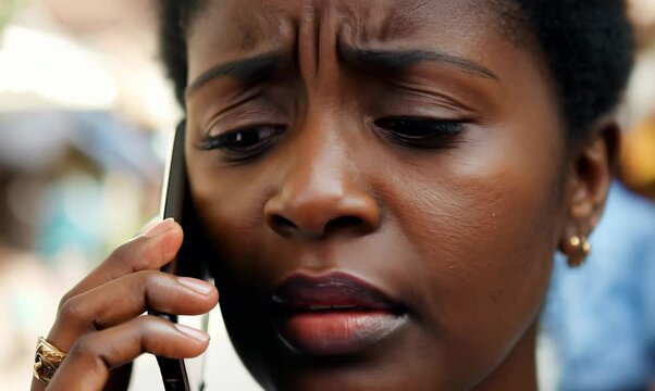 Malawian Woman Scheduling a Dentist Appointment on Phone