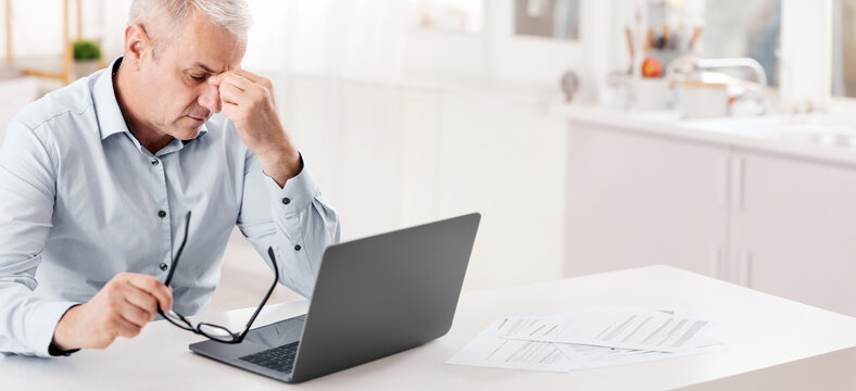 Thinking About Problems. Fatigued senior businessman massaging nosebridge with closed eyes, free space