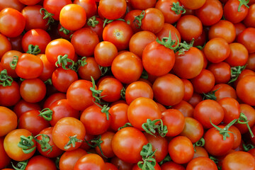 Ripe red cherry tomatoes at a retail market or hypermarket.