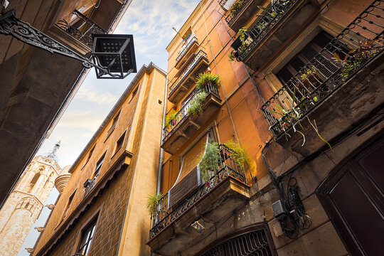 Barcelona, Spain, Low angle view at the architecture details of Gothic Quarter. Buildings with balconies and antique lantern.