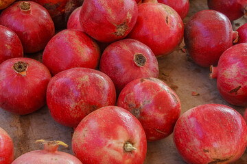 Pomegranates sold in a market shelf in autumn
