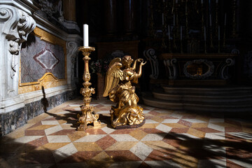 Golden angel at a side altar in the Basilica of San Petronio, Bologna, showcasing Baroque richness,...