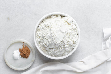 All purpose flour in a ceramic bowl, baking flour in a bowl