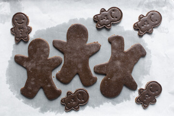 top view of gingerbread man cookie dough, Overhead view of cut out gingerbread molasses cookie dough on a marble countertop, process of making gingerbread christmas cookies