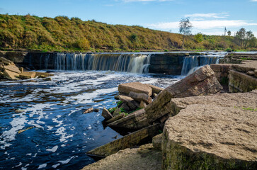 Tosnensky (Chernovsky) waterfall on a sunny October day.  It is part of the Sablinsky Natural...