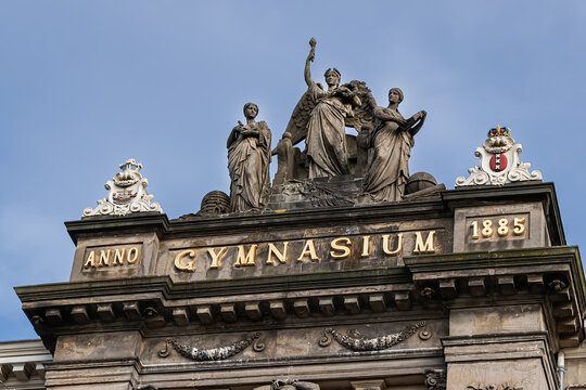 Architectural fragments of Stedelijk Gymnasium building in neoclassical style (1884 &ndash; 85). In 1926 it was renamed Barlaeus Gymnasium. National monument. Amsterdam, The Netherland. March 21, 2022.