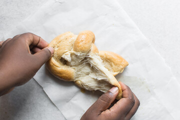 overhead view of bread being pulled apart, top view of bread with good gluten development being...