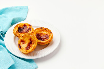 Traditional Portuguese egg tart dessert Pasteis Pastel de nata or Pasteis de Belem on the plate over white background