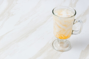 Es Kelapa Jeruk, a typical Indonesian drink made from fresh oranges squeezed with grated young coconut. with copy space. perfect for recipe, article, catalogue, or any commercial purposes.