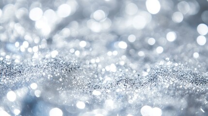 Fototapeta premium Sparkling silver bokeh lights create an abstract, shimmering background.