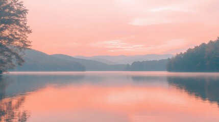 Fototapeta premium Serene lake with a soft pink sunset reflecting on the water.