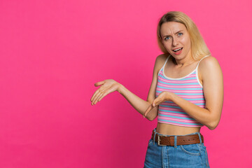 Woman raising hands asking what why reason of failure, demonstrating disbelief irritation by...