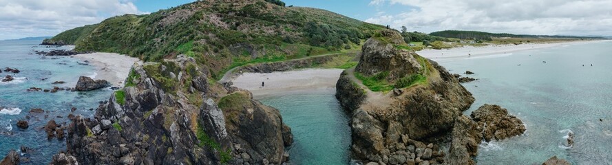 Rocky cove headland at Te Arai Beach, Auckland, New Zealand.