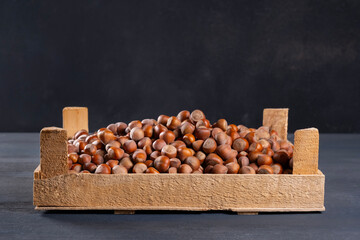 Pile of hazelnuts in a wooden crate