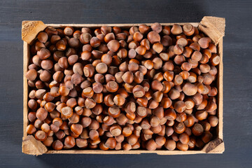 Pile of hazelnuts in a wooden crate