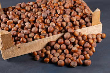 Pile of hazelnuts in a wooden crate