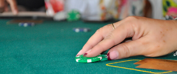 Hand holding a casino chip