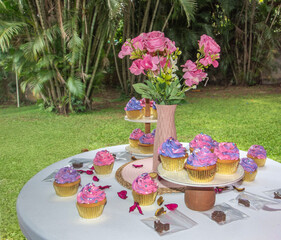 A table decorated with roses and cupcakes