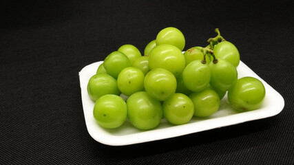 Fresh green grapes in packaging isolated