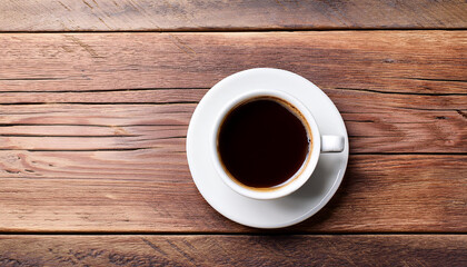 Cup of coffee on a wood table background. Top view with copy space