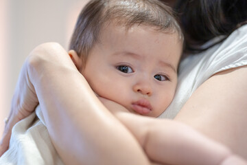 A 6-month-old baby held by a woman in her 30s inside a building near Dihua Street in Taipei City, Taiwan, in September.