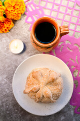 Pan de Muerto with Café de Olla, Marigold Flowers, and Lit White Candle