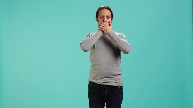 Man covering eyes, ears and mouth, imitating three wise monkeys. Arab person doing dont see, dont hear and dont speak hand gesturing concept, studio background, camera A