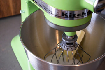 Green KitchenAid Mixer with Whisk and Butter in Bowl