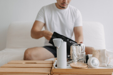 Step by step of Asian man making espresso with hand press tools.