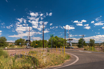 A road leading to a railroad crossing in Ash Fork, Arizona, USA on a sunny summer day