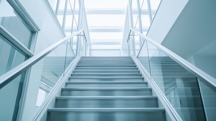 Fototapeta premium Low-angle shot of a metallic-finished staircase, emphasizing the sleek, modern design and the lavish surroundings of a high-end home