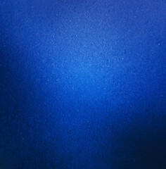 Abstract close-up of a blue textured background featuring a smooth gradient effect and subtle surface details.