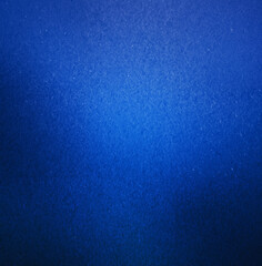 Abstract close-up of a blue textured background featuring a smooth gradient effect and subtle surface details.
