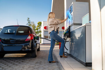 Futuristic concept of paying gas with mobile phone scanning qr code or using an app. Attractive...