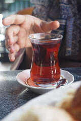 woman drinking Traditional turkish tea on white table .
