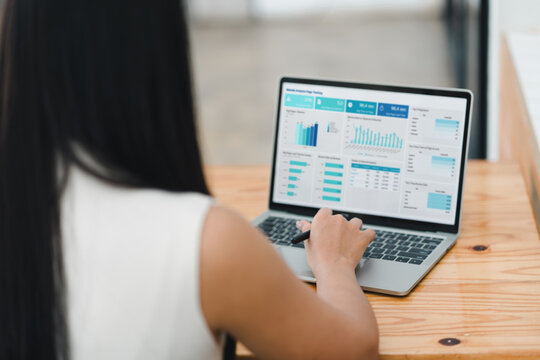 person analyzing data on laptop, focusing on various charts and graphs displayed on screen. setting suggests modern workspace, emphasizing productivity and technology - Powered by Adobe