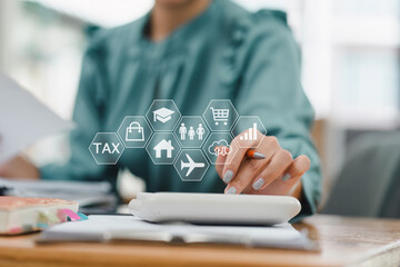 Efficiently managing finances, woman uses calculator while surrounded by various financial icons representing tax, education, shopping, and travel