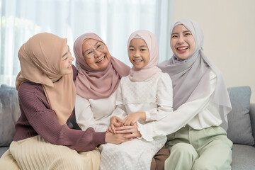 Fototapeta premium three different female generations meeting at home,sitting on couch in living room,hugging with love, smile,affection,enjoy holiday time together