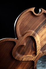 Wooden heart-shaped serving bowl for snacks, fruits, nuts, cheeses, meats and original serving of main dishes. Luxury products from hard and exotic wood species. Accessories for a modern kitchen.