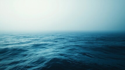 Obraz premium A Vast, Blue Ocean Under a Foggy Sky