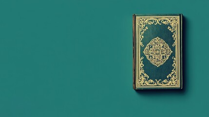A minimalist image of the Kit&Atilde;&iexcl;b-i-Aqdas isolated against a solid green background. The sacred text&acirc;&euro;&trade;s ornate cover stands out boldly, highlighting simplicity and Bah&Atilde;&iexcl;'&Atilde;&shy; spiritual law