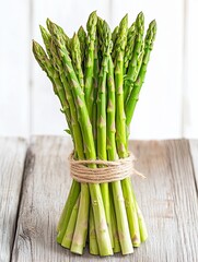 Freshly harvested asparagus bundle on rustic wooden table