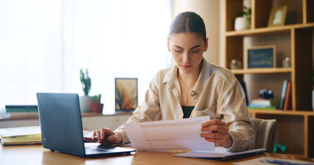Woman, reading and document with laptop at house for loan approval, bank application and budget...