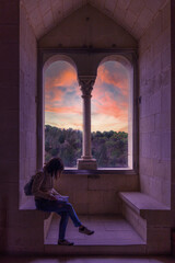 Woman reading at sunset inside the Alcazar