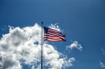 American Flag Blowing in the Wind with Cirrus Clouds Overhead.